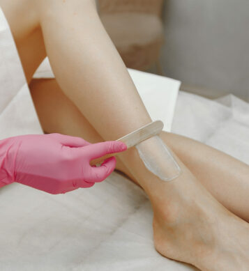Hair removal. Gel for laser. Woman in a pink gloves.